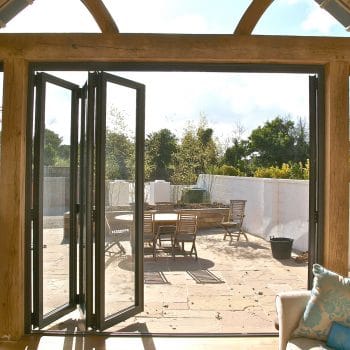 internal image of bifold doors in a large timber frame