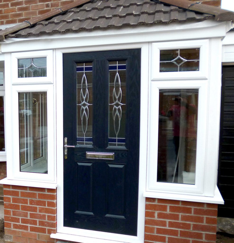 white upvc porch with a blue composite door and tiled roof