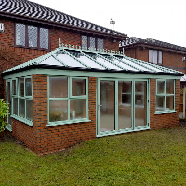 Chartwell Green conservatory with glass roof and bi fold doors