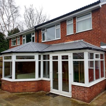 P shape conservatory with solid roof and french doors