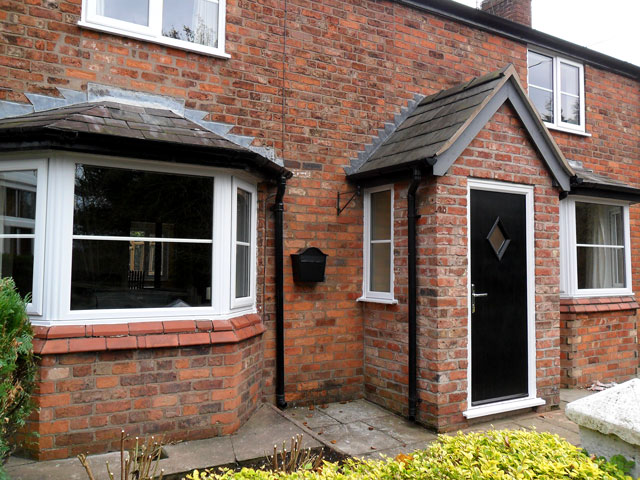 bay windows in white upvc with black cottage door